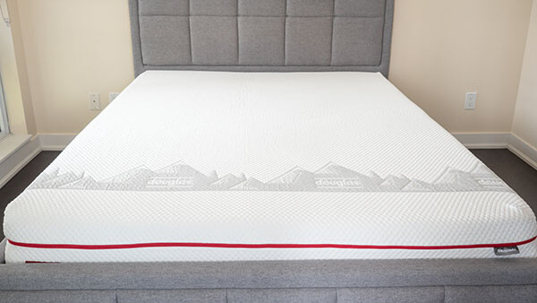 A latex mattress on a bed frame